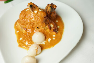 Delicious Chicken Tikka Masala with Lychees on White Plate