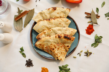 Delicious Indian Naan Bread with Spices on a Plate