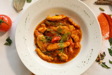 Delicious Chicken Tikka Masala in a White Bowl with Spices