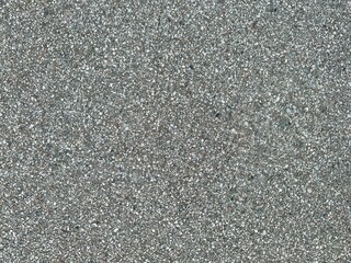 Granular asphalt background with rough texture and mixed pebbles. Ideal for construction or street themes.