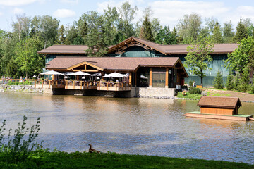 panoramic view of waterfront lodge and floating duck house