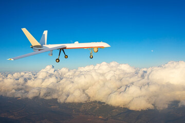 Combat drone flies high in the sky sunset clouds. Modern warfare and drones spy.