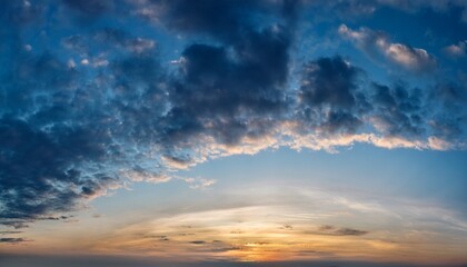 Obraz premium sunset sky in bright blue tones a wide panorama of the evening sky covered with dark clouds