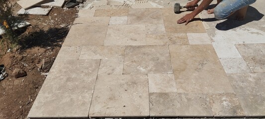 man on the stairs Workers laying paving stones on construction site