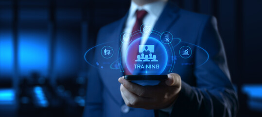 Obraz na płótnie Canvas Businessman Holding smartphone with Training Icons on Screen. E-Learning and online Education concept