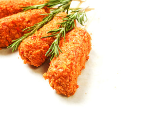 Fancy meat kebab on a wooden sticks with rosemary fresh herb on white background. Barbeque meal made of fine beef or lamb meat.