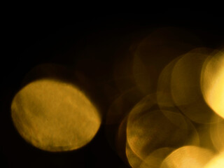 Abstract bokeh scene. Golden light leaks on black color background for design. Light effect.