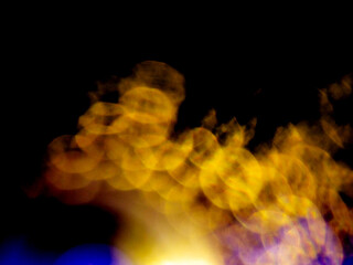 Abstract bokeh scene. Golden and blue glowing light leaks on black color background for design....