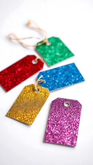 Six Glitter Gift Tags in Assorted Colors on White Background vertical