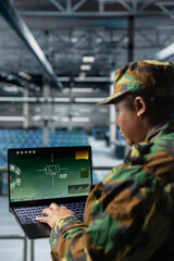 Close up of army expert in data center scanning terrain in real time using military satellite...