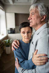 Senior woman in husband embrace comforting thoughtful sad mood. Marital support in hardships,...