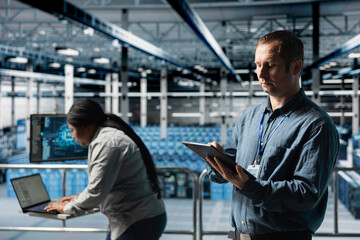 Team of data center technicians analyzing equipment performance, resolving hardware failures....