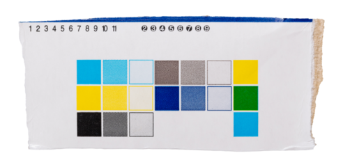 Color reference bars of printing on piece of cardboard from beverage pack. Offset print calibration