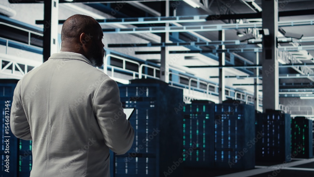 Poster data center system administrator checking infrastructure diagnostics using tablet screen. it special