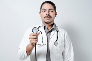 Doctor showing blood pressure monitor isolated. Male doctor holding tensometer