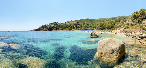 View to Cannelle beach, Spiaggia delle Cannelle, near Giglio Porto with view to mediterranean sea and beautiful blue bay at Isola del Giglio, island of the tuscan archipelago, Grosseto Tuscany Italy