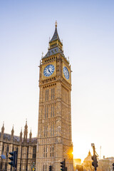 Big Ben towers over the London skyline, basking in soft golden sunlight during early evening. The...