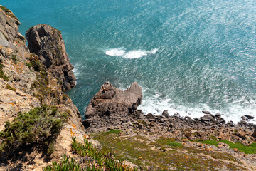 Steep rocky cliffs meet the vibrant turquoise Atlantic Ocean in the Lisbon area, perfect for nature, travel, and adventure themes. Ideal for scenic landscape inspiration. © Flash Vector