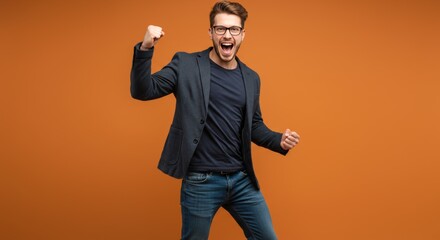 Excited man in blazer and jeans celebrating success, full body studio shot, orange tone