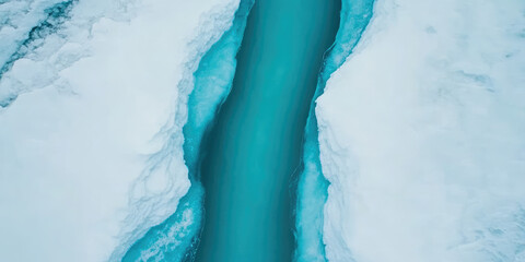 A narrow turquoise river runs through thick white ice, creating a striking contrast. Concept: nature, cold, pristine environment