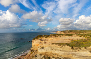 Spectacular Pacific coastline landscape at sunset, colorful beach with cliffs from aerial view , Peniche, Portugal