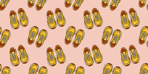 Seamless autumn pattern with yellow cartoon sneakers on pink background. Sport and casual shoes. Cartoon vector style