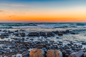 Sunset at the Seaside with black rocks
