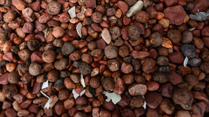 Frame full of decorative brown stones. Texture. Background.