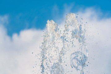 Splashes and jets of water against light background.