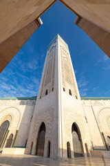 Ornate mosque minaret against a clear sky.