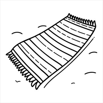 Stripped towel with fringed ends on a surface with a few small lines indicating sand