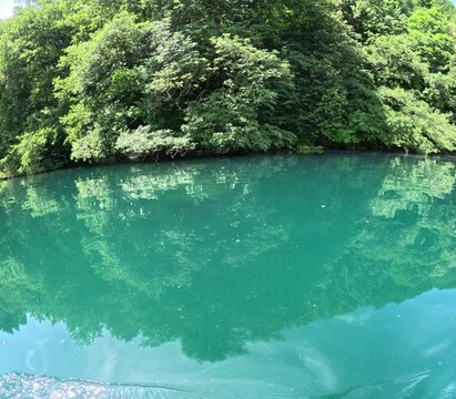 Lake of Levico in Trentino, northern Italy, seen during a hike on a stand up paddle board on a beautiful day in June