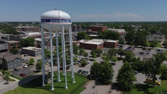 lower flying past iconic water tank towards downtown Bentonville Arkansas
