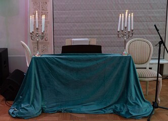 Elegant event setup with piano and candlelight.
