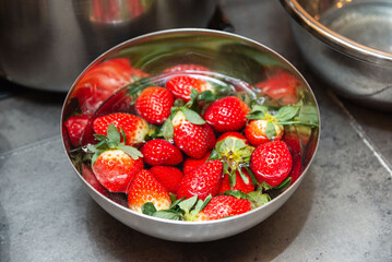 Fresh strawberries soaking in water.