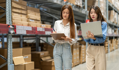 Female engineers team discussing inventory in warehouse logistics and supply chain planning,...