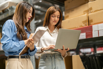 Female engineers team discussing inventory in warehouse logistics and supply chain planning,...