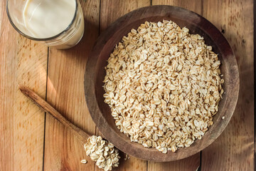 top view of oats in a plate with milk on a wooden table