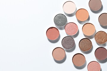Beautiful eyeshadow refill pans on white background, flat lay. Space for text