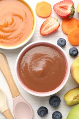 Baby food. Tasty puree in bowls and different ingredients on white wooden table, flat lay