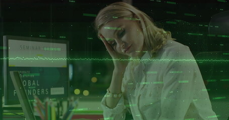 Reviewing data, woman in white blouse using laptop in office at night, with data overlay