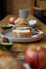 The table displays a variety of breakfast foods including fresh bread, fruits, eggs, and steaming drinks, creating a warm and inviting atmosphere for a perfect morning meal.

