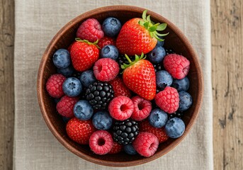 Obraz premium Rustic Bowl Overflowing with Fresh Strawberries, Raspberries, Blueberries, and Blackberries