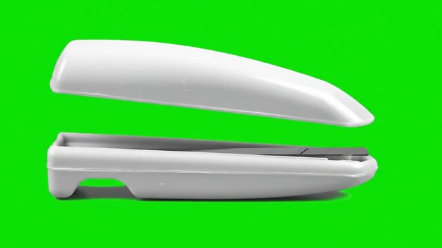 stapler on green background