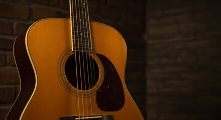 An elegant close-up of a vintage acoustic guitar resting against a dark, rustic brick wall. The focus is on the strings over the soundhole. Warm, moody, intimate lighting.
