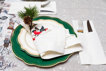 Elegant Christmas Table Setting with Embroidered Napkin.