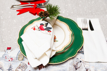 Elegant Christmas Table Setting with Bullfinch Napkin.