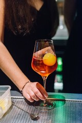Orange Cocktail with Ice Sphere in Wine Glass.