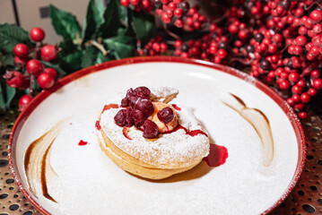 Cream Puff Dessert with Cherries and Powdered Sugar.