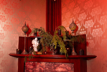 Elegant Fireplace Decor with Greenery and Statue.